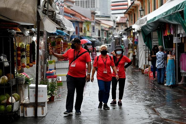 Safe distancing ambassadors in Little India in January. Singapore has reintroduced some measures as a new wave of Covid-19 infections spreads through the community.