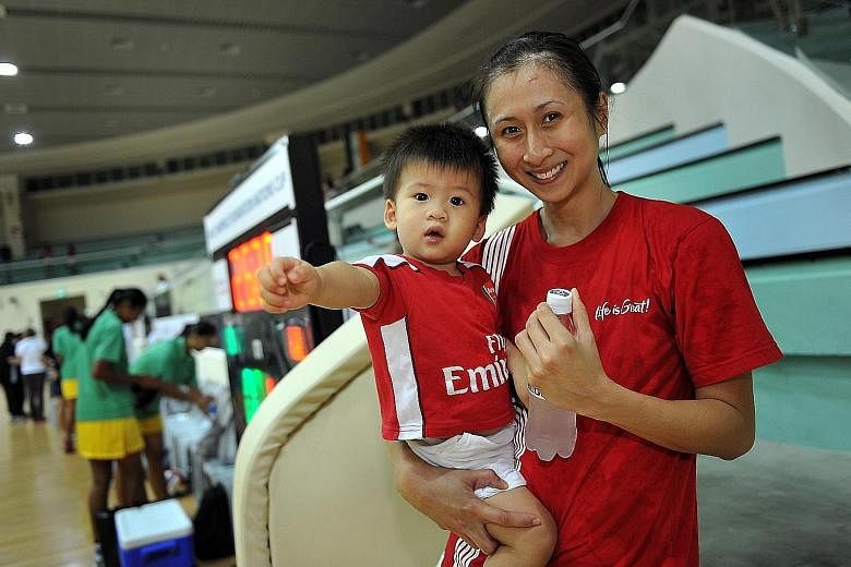 Former national netball captain Pearline Chan with son Tyler. She remembers going for her first 5km run four months after having him by C-section in June 2009. By December, she was playing for Singapore again. Yvonne Chee ran a then-personal best of 