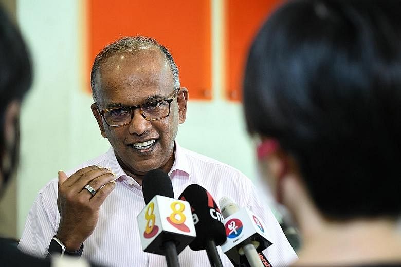 Law and Home Affairs Minister K. Shanmugam speaking to reporters at a constituency event yesterday. He said that it is vital for the media to retain the trust of the public, as media that is not trusted will lead to a government and political leaders