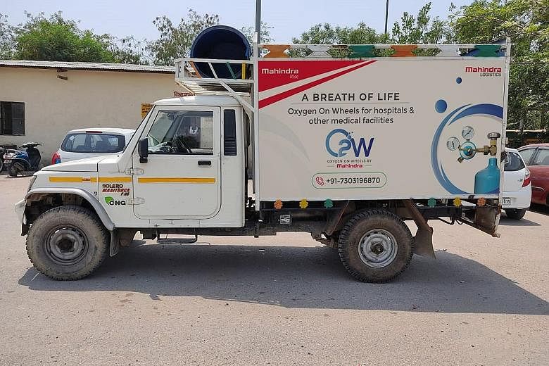 A body being carried to an open-air crematorium set up for coronavirus victims, inside a defunct granite quarry on the outskirts of Bangalore on Saturday. As India's Covid-19 crisis deepens, some of its large corporate houses have rolled out help. Co