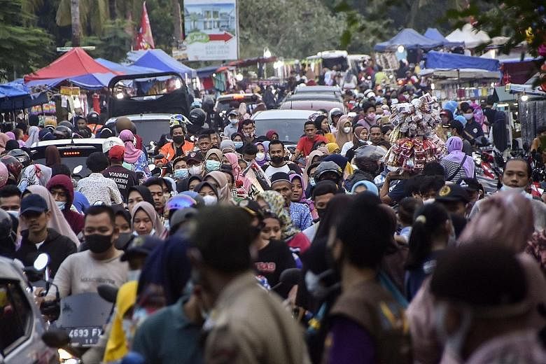 Crowds at a market in Bekasi, West Java, on Sunday. Despite a ban on heading back to their hometowns for Hari Raya Aidilfitri, some Indonesians have managed to sneak past the 381 checkpoints set up across Sumatra, Java and Bali. Only those on officia
