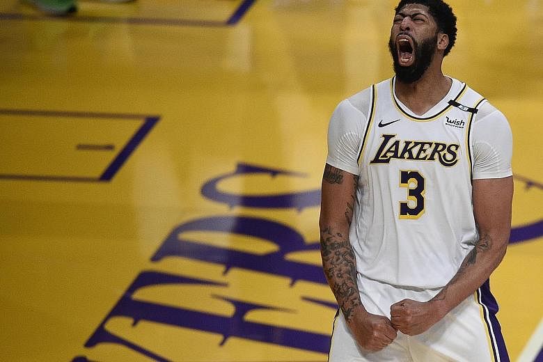 Lakers forward Anthony Davis is ecstatic after a dunk against the Suns at Staples Centre on Sunday. He led all scorers with 42 points in his team's 123-110 win. PHOTO: REUTERS