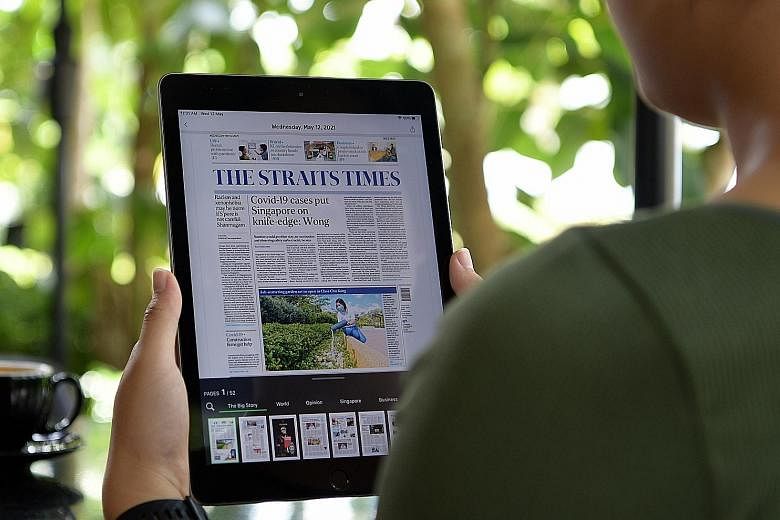 A reader using a tablet to read The Straits Times. Former Cabinet minister Khaw Boon Wan, who will be the chairman of the to-be-formed SPH Media Trust, aims to improve the user interface and user experience of the new media entity's digital products.