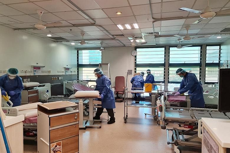 Housekeeping staff disinfecting Tan Tock Seng Hospital's (TTSH) Ward 9D, the nucleus of the recent Covid-19 outbreak at the hospital. The layout of C class wards in older hospitals like TTSH makes it difficult to prevent the spread of an in-hospital 