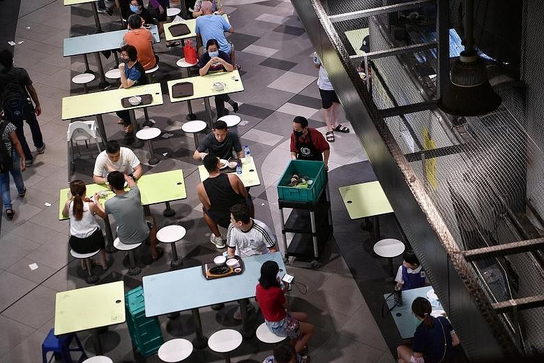 Right: Clearing dirty trays, crockery and table litter will protect not just other diners, but also cleaners, who are usually seniors. Bottom right: An SG Clean campaign sign on a table at the Clementi 448 Market and Food Centre, urging diners to kee