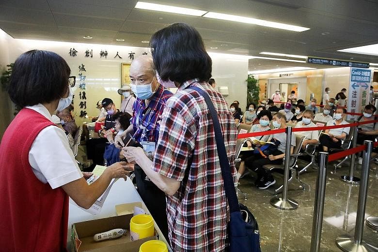 People inquiring about Covid-19 vaccinations at the Far Eastern Memorial Hospital in New Taipei City, Taiwan, on Thursday. Mounting infections have led to a renewed interest in vaccinations on the island.
