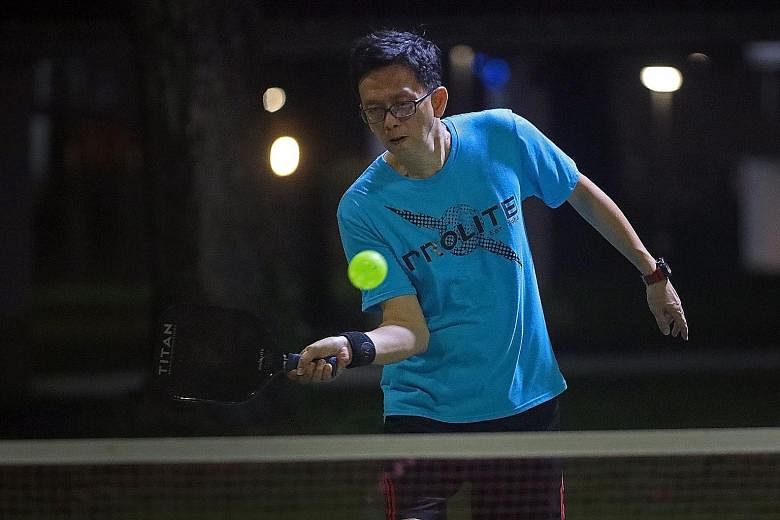 Janice Kuok (far left), 12, started playing pickleball last September. She now plays at least once a week at an outdoor court in her neighbourhood in Jurong West. ST PHOTOS: JASON QUAH