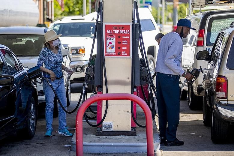 Motorists filling their tanks following a petrol delivery to a station in Alexandria, Virginia, on Thursday. Colonial Pipeline said it has restarted its entire pipeline system but it will take several days for shipments to return to normal.