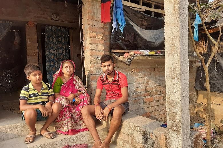 Above: Widow Sabita Mondal and her two sons at their house on Satjelia island. Her husband was among 24 reported tiger attack victims in the Sundarbans last year.