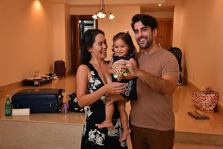Mr Sayjel Patel with his wife Joy and their 17-month-old daughter Eleanor in their rented three-bedroom condo unit in River Valley. ST PHOTO: CHONG JUN LIANG