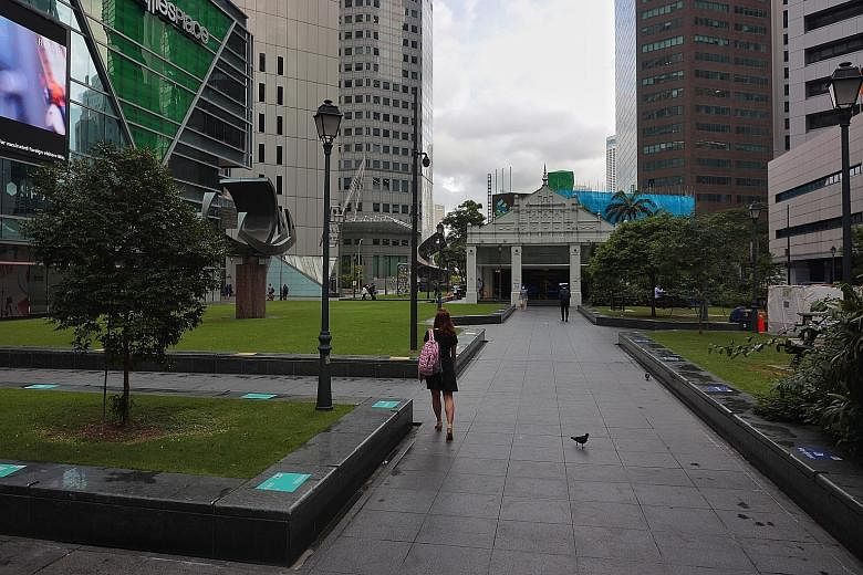 The usual office crowd was missing in Raffles Place at 8.40am yesterday, as Singapore moved to working from home as the default. ST PHOTO: JASON QUAH