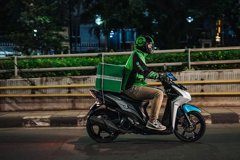 A Gojek rider delivering a Tokopedia package in Jakarta. The entity formed by the merger of Gojek and Tokopedia, called GoTo, had a combined gross transaction value of over US$22 billion (S$29.4 billion) last year. It has more than two million ride-h