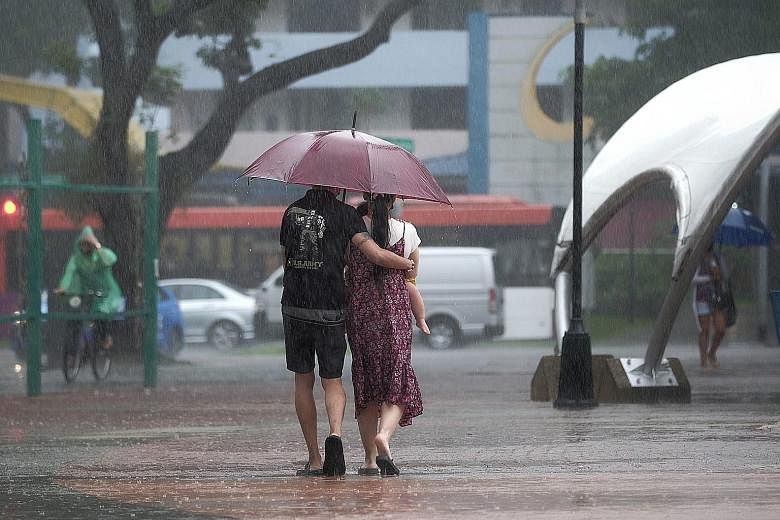 People braving the rain in Toa Payoh Central (above and right) and in Upper Bukit Timah (below) yesterday. According to weather and climate scientist Koh Tieh Yong, sea breezes converging over the country bring about squall-like storm systems that ca