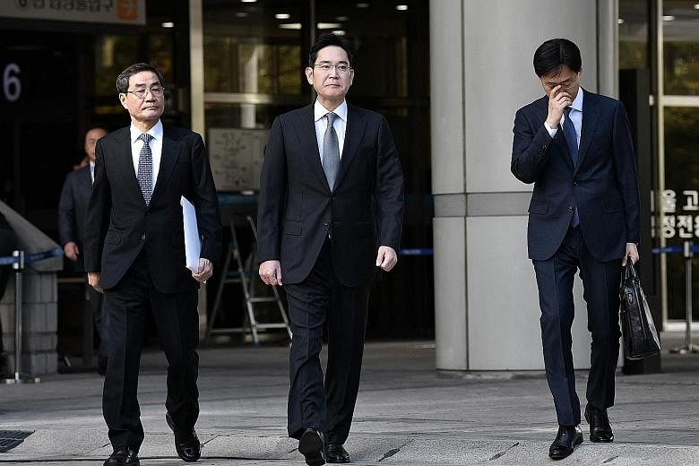 A 2019 file photo of Samsung Electronics vice-chairman Lee Jae-yong (centre) leaving the Seoul High Court after a retrial. He was thrown behind bars in January for bribery and embezzlement. PHOTO: AGENCE FRANCE-PRESSE