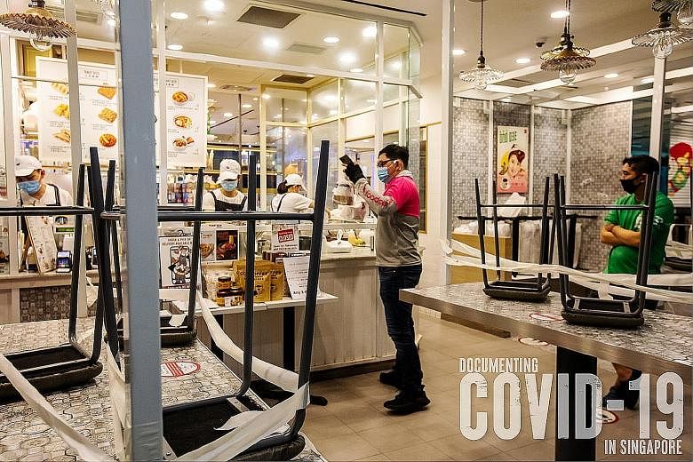 About 4,100 items have been submitted for Documenting Covid-19 in Singapore project. Among them are three photos from a year ago - of stacked-up chairs at a Toast Box outlet, queues for takeaway at a Din Tai Fung restaurant, and a taped-up hawker cen