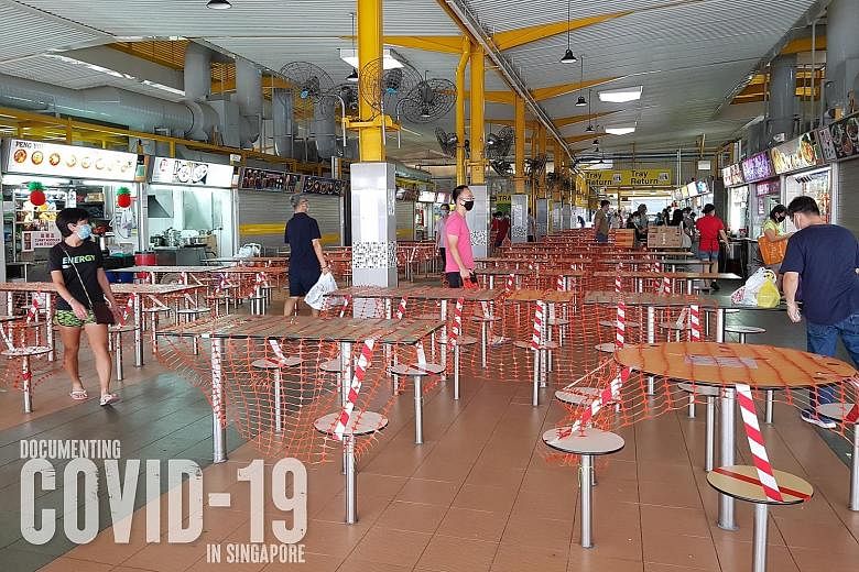 About 4,100 items have been submitted for Documenting Covid-19 in Singapore project. Among them are three photos from a year ago - of stacked-up chairs at a Toast Box outlet, queues for takeaway at a Din Tai Fung restaurant, and a taped-up hawker cen