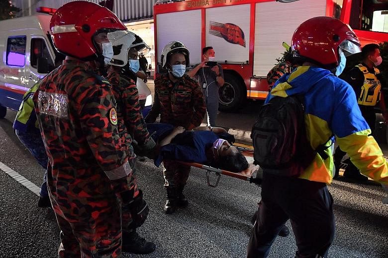 Left and above: Victims being attended to by emergency personnel. The seriously wounded were taken to hospital. Right: A picture posted on social media shows people lying on the floor of a train carriage with broken glass around them. PHOTOS: BERNAMA