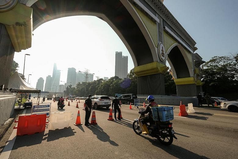 THAILAND People being tested for the coronavirus at a carpark in Bangkok on Monday. Thailand has reported 135,439 infections and 832 deaths since the pandemic began last year. PHOTO: EPA-EFE MALAYSIA A border checkpoint between Kuala Lumpur and Selan