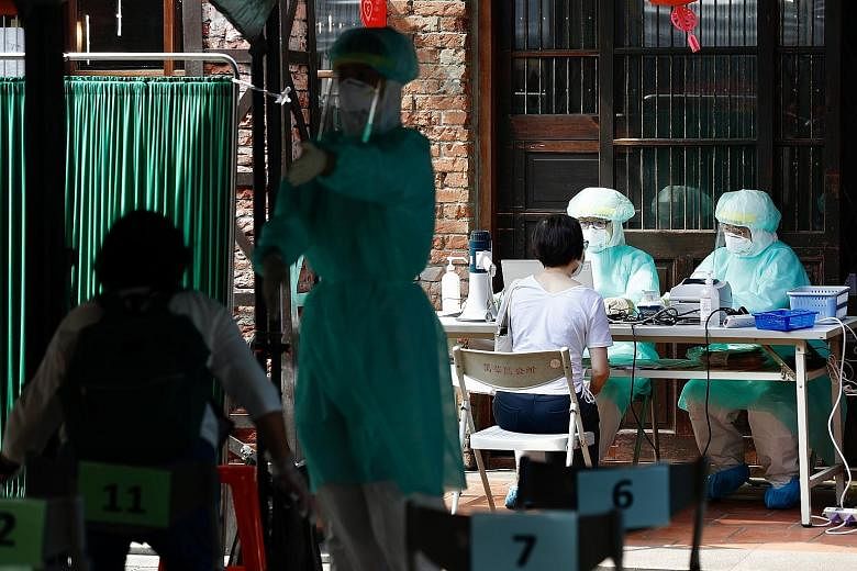People registering to take a Covid-19 test at a testing facility in Taipei on Tuesday. The number of people seeking tests has sharply increased over the past two weeks, stretching testing facilities which are now struggling to keep up, according to d