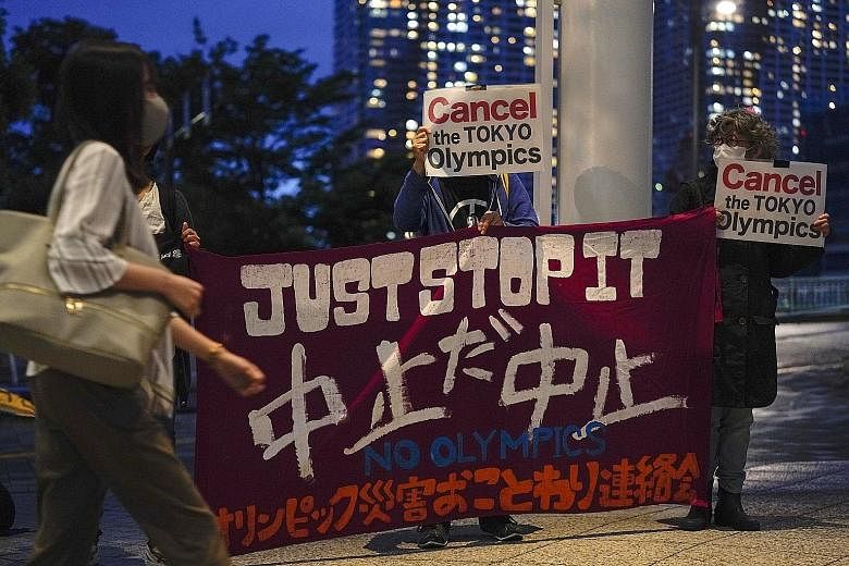 Protesters, who are against the Tokyo 2020 Olympics being held amid the pandemic, appealing to pedestrians in the capital city last Friday.
