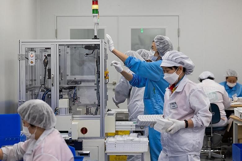 Staff working on a Covid-19 testing kit in Gunpo, South Korea, earlier this month. Dr Jerome Kim, director-general of the Seoul-based International Vaccine Institute, said more opportunities could come for South Korea if the two other firms making mR
