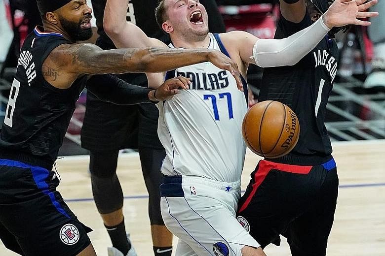 Mavericks guard Luka Doncic being fouled by Clippers forward Marcus Morris Sr. The Slovenian is once again a thorn in the Clippers' side, having starred against them in this and last season's play-offs, including a buzzer beater to win Game 4 last ye