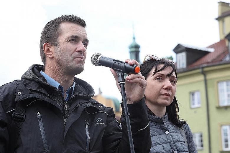 Mr Dmitry Protasevich and his wife Natalia (above), parents of detained journalist Roman Protasevich (left), calling for the release of their son and his girlfriend Sofia Sapega (far left), at a rally in Warsaw last Saturday. Their son and his girlfr