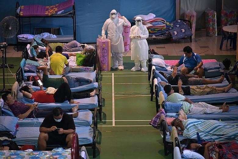 Malaysian health workers in full protective gear on duty at a Covid-19 quarantine centre in Labuan yesterday. The total daily cases in the country dipped slightly to 6,999 new infections yesterday, with 79 deaths, but active cases continued to climb,