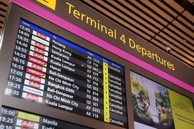 A list of cancelled flights at Changi Airport Terminal 4 in March last year. In a year of global travel curbs, around half of the pandemic-related complaints that Case received were against the travel and airline sectors. ST PHOTO: ALPHONSUS CHERN