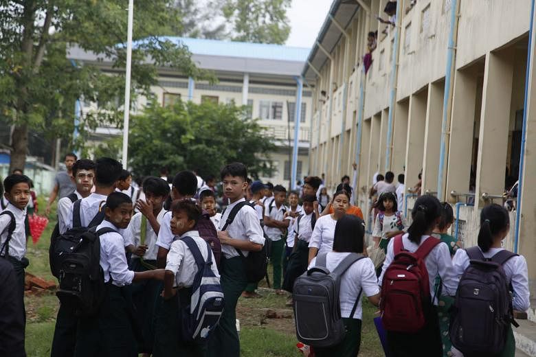 Students gathered yesterday at a primary school in Sittwe in Myanmar's Rakhine state. Schools reopened yesterday for the first time since the military seized power in February, but teachers and students defied the junta's calls for full classrooms in