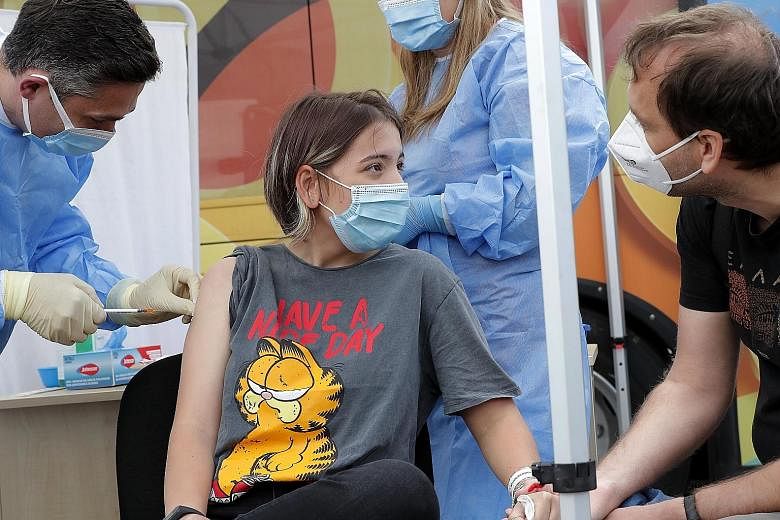 Alexandra Maiorescu, 12, getting her Covid-19 jab in Bucharest on Wednesday, as Romania and other places rolled out vaccines for the young.