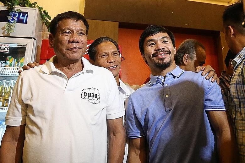 A 2017 photo of Philippine President Rodrigo Duterte (left) with boxing icon and newly elected Senator Manny Pacquiao in Davao. PHOTO: AGENCE FRANCE-PRESSE