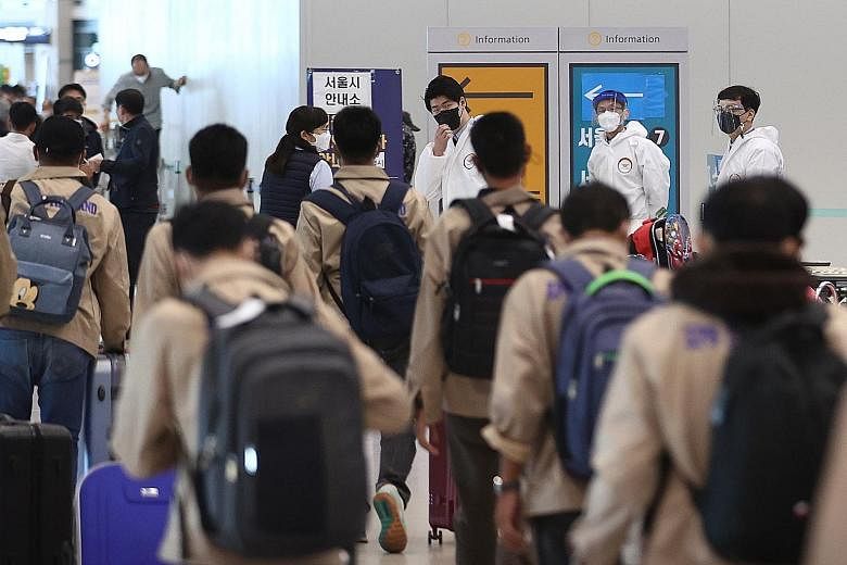 Overseas arrivals undergoing quarantine procedures at South Korea's Incheon International Airport on May 21. Industry sources have named Singapore among potential partners for an air travel bubble with South Korea.