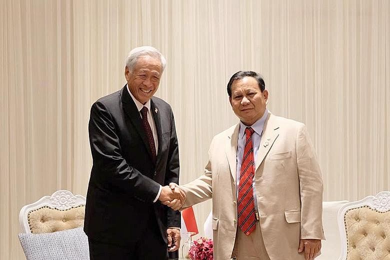 Singapore's Dr Ng Eng Hen and Indonesia's Mr Prabowo Subianto on the sidelines of the Asean Defence Ministers' Meeting in Bangkok in 2019. PHOTO: MINDEF