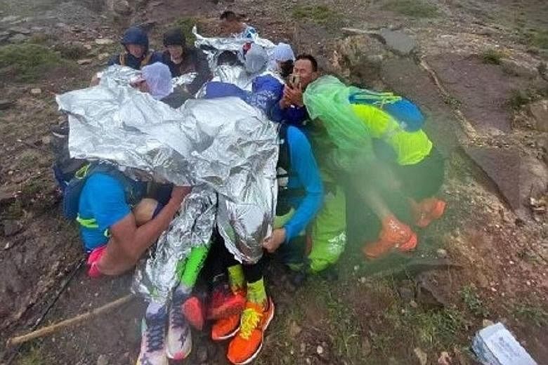 Runners huddling for warmth. The race on May 22 has been called one of the most tragic events in the history of long-distance running.