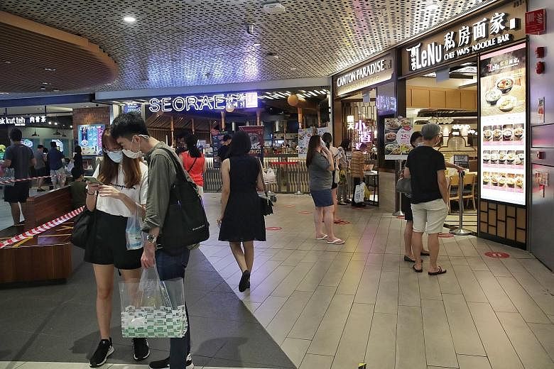 Even as Jem welcomed shoppers (above) back yesterday, the mall will continue to maintain its enhanced cleaning regime (left) and safe distancing protocols, said its operator Lendlease Singapore. Shoppers (above) at Westgate yesterday, the first day o