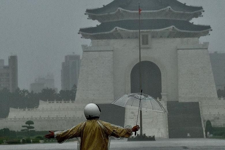 The Chiang Kai-shek Memorial Hall seen in the background as Tropical Storm Choi-Wan brought heavy rain to Taipei on Friday. Taiwan is dealing with its worst drought in history. There were no direct hits from typhoons last year, meaning much less rain