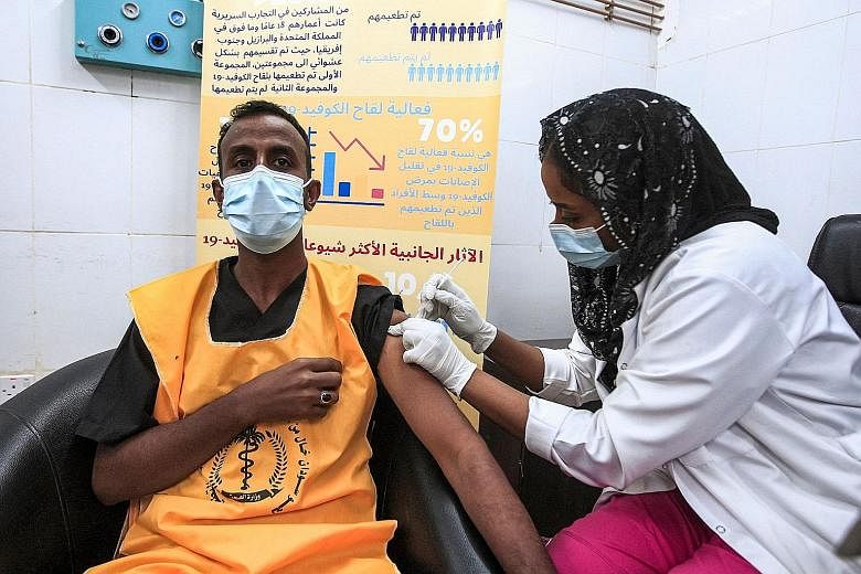 Above: A medical worker in Khartoum, Sudan, getting a dose of AstraZeneca's vaccine. Countries like Syria and Sudan have barely vaccinated 1 per cent of their population. Left: A teenager in Israel getting his jab on Sunday. The country has inoculate