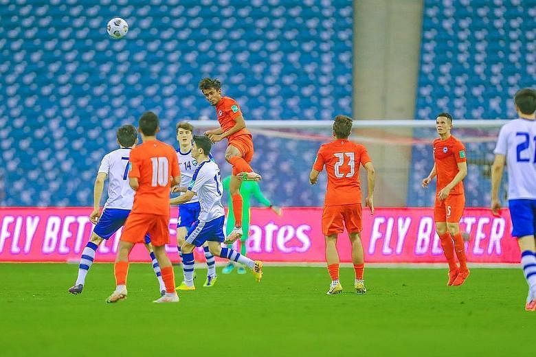 Singapore (in red) failed to register a shot on target against Uzbekistan in their 2022 World Cup qualifier on Monday. PHOTO: FAS