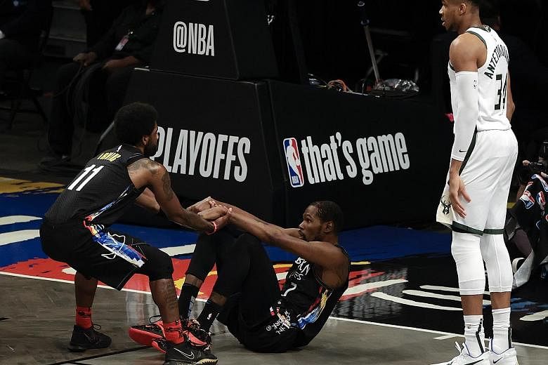 Nets forward Kevin Durant (on the ground) scored a game-high 32 points as his side handed the Bucks their second loss in the series.