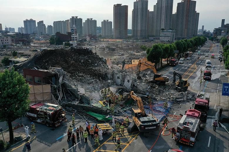 Firefighters carrying out rescue operations after a five-storey building collapsed, burying a bus with passengers in the city of Gwangju, South Korea, yesterday.
