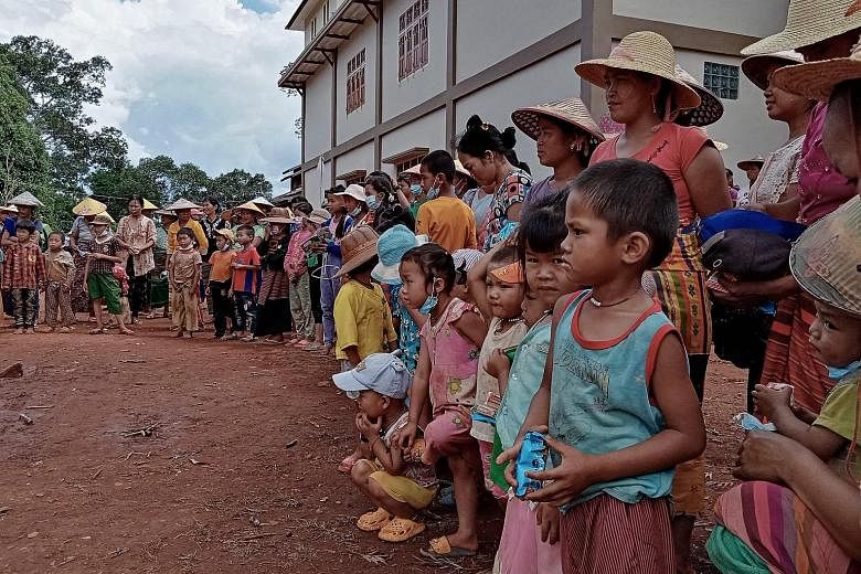 Families displaced by recent fighting between government troops and ethnic rebels waiting for food distribution from a volunteer group while taking refuge at a monastery in Namlan town, in Myanmar's eastern Shan state, last month. The country has bee