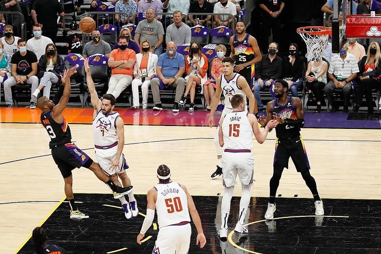 Phoenix Suns guard Chris Paul putting up a shot against Facundo Campazzo of the Denver Nuggets during Game 2 of their NBA Western Conference semi-final series. The Suns won 123-98 to take a 2-0 lead.