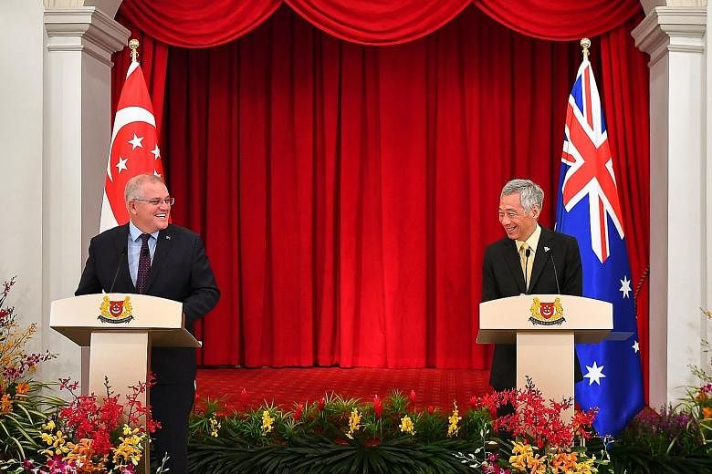 Prime Minister Lee Hsien Loong and Australian Prime Minister Scott Morrison at a joint news conference at the Istana after their meeting yesterday. PM Lee said the two leaders discussed the fight against Covid-19 and resuming travel between their cou