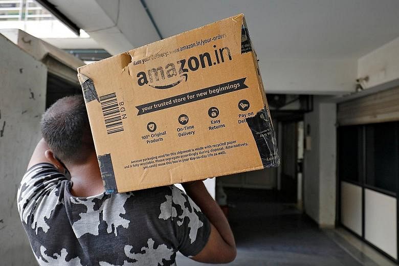 An Amazon worker delivering a package at a residential building in Ahmedabad, India, on March 17. Despite Amazon's colossal footprint and market capitalisation of more than US$1 trillion (S$1.3 trillion), its profit margin last year amounted to just 