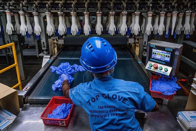 A worker in a Top Glove factory in Shah Alam, Malaysia, last year. The firm's strong third-quarter performance was mainly due to technological advancements and research and development, it noted in a filing.