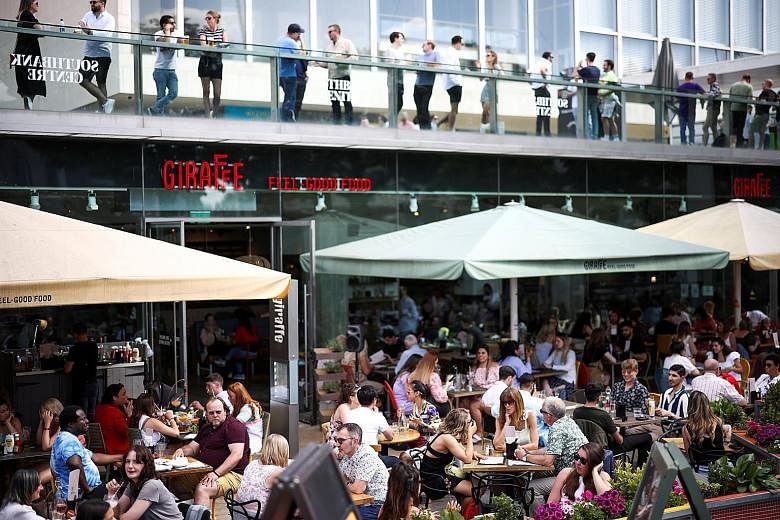 Diners at an outdoor restaurant on the South Bank in London last Saturday. The reopening of shops, hairdressers and restaurants serving outdoors after months of lockdown boosted the British economy in April. A rapid vaccination programme means Britai