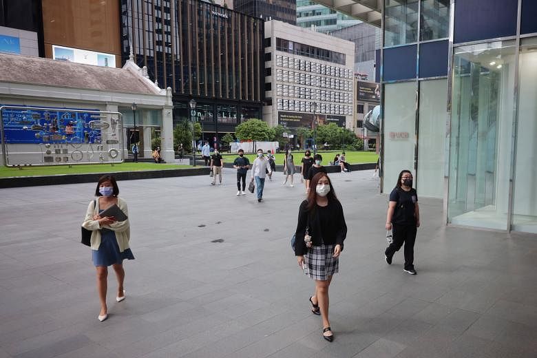 Office workers at Raffles Place on May 17, the second day of tightened Covid-19 measures in Singapore. Bosses should not use non-vaccination as a reason to terminate employment as there could be medical reasons for staff not getting a jab, said Insti