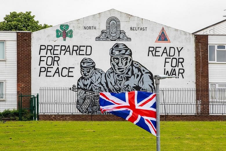 A Union Jack in front of an Ulster Volunteer Force mural in Belfast, the Northern Irish capital. Britain and the European Union are in a war of words over part of the Brexit deal covering border issues with Northern Ireland.