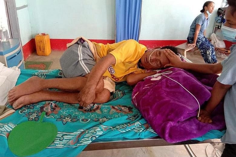 A Covid-19 patient being comforted by a family member at a hospital in Cikha, Myanmar, on May 28. The presence of soldiers, stationed at more than 50 hospitals and other healthcare centres since the coup, has deterred many people from seeking care. S